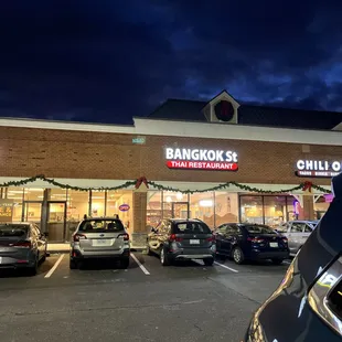 cars parked in front of a restaurant