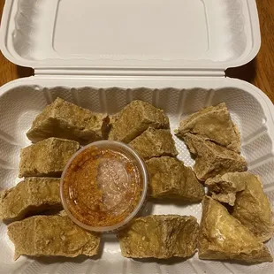 a tray of tofu and dipping sauce