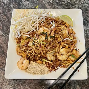 a plate of food with chopsticks