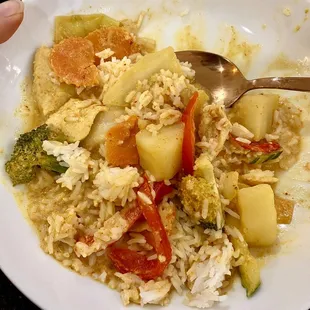 Yellow curry with veggies, red peppers, chicken, broccoli and potatoes.