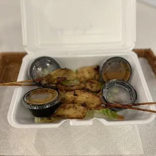 Chicken Stay on wood skewers, with peanut sauce on side (take-out).