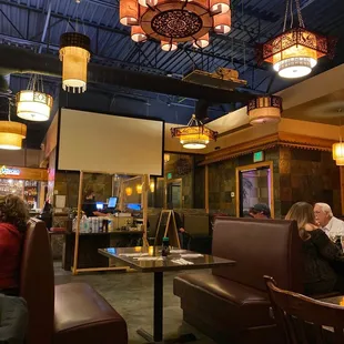people sitting at tables in a restaurant