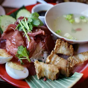 KAO MOO DANG MOO KROB Bangrak crispy pork belly and Chinese BBQ pork over steamed jasmine rice topped.