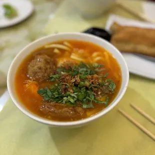 a bowl of soup with meatballs and vegetables
