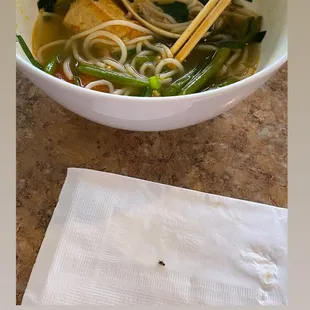 a bowl of noodles and chopsticks