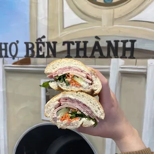a person holding a sandwich