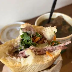a person holding a sandwich