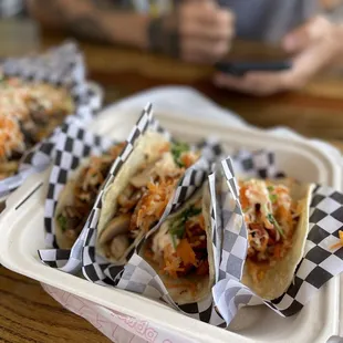 three tacos on a table