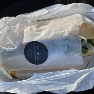 a sandwich wrapped in a plastic bag