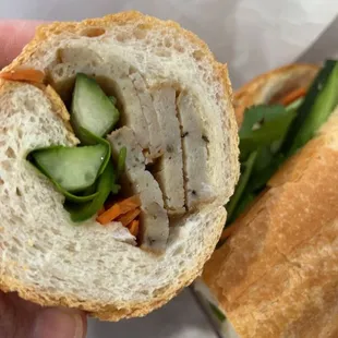 a person holding a sandwich