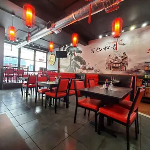 a restaurant with red chairs and tables