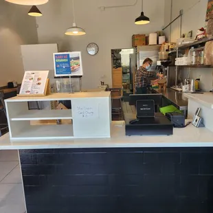 Front counter and owner making Vietnamese iced coffee