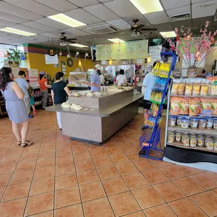Order counter is straight ahead and to the left. A lot of packaged food for sale on the shelves.