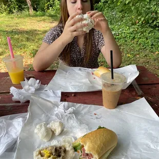 Eating at a local park with best ever banh mi and steamed pork meatball bun.