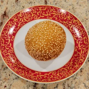Fried donut with sesame seeds