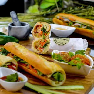a variety of sandwiches on a cutting board