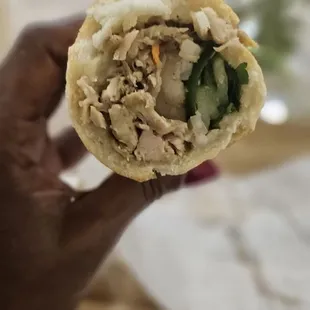 a hand holding a sandwich