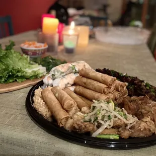 Party Tray with spring rolls, egg rolls, calamari, chicken wings (2 types - house and garlic butter), pork skewers