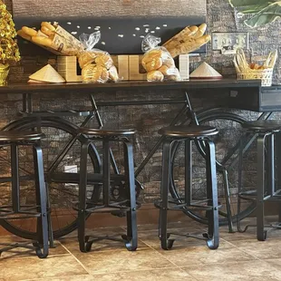 Cute table using a bike. That fresh bread ready to buy.