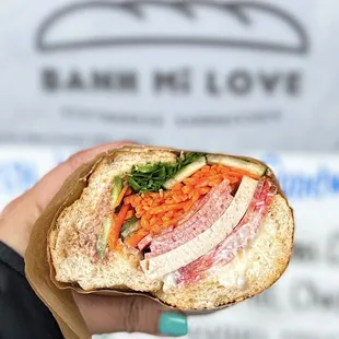 Combo Pork w/ pâté, fancy pork, headcheese, roasted pork, mayo, and fixings | $8.75 (half portion shown)