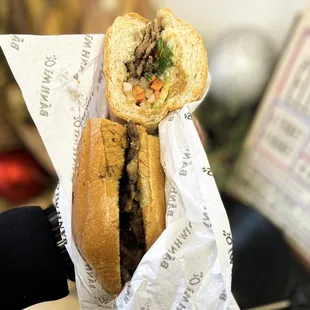  a hand holding a sandwich