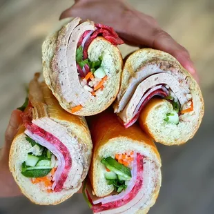 a person holding a sandwich