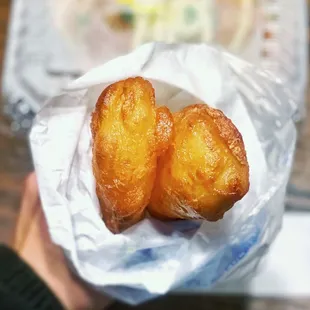 a person holding a piece of bread