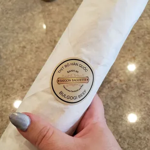 a person holding a baguette