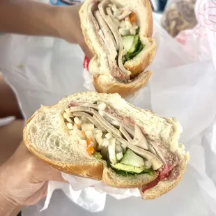 a person holding a sandwich