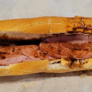 Charbroiled pork banh mi. Slices of ham with terrible brown sauce