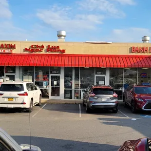 View from the parking lot. Restaurant is the last store on the right.