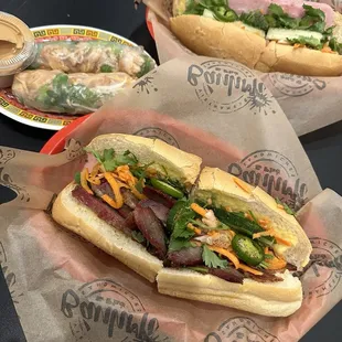 BBQ pork banh mi (bottom), classic banh mi, chicken spring rolls