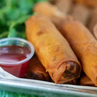 a plate of food with dipping sauces