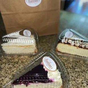 Slice of Blueberry Cheesecake, Slice of s&apos;mores cheesecake, Slice of Coconut Cream Cheesecake