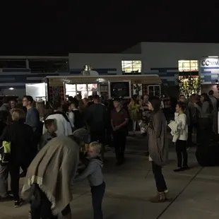 a large group of people standing in a parking lot
