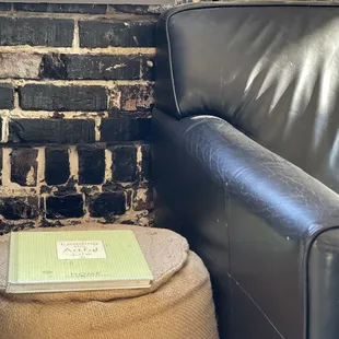 a black leather chair and ottoman