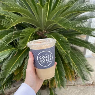 a hand holding a cup of coffee