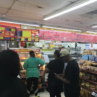 The line waiting to order sandwiches at the counter.