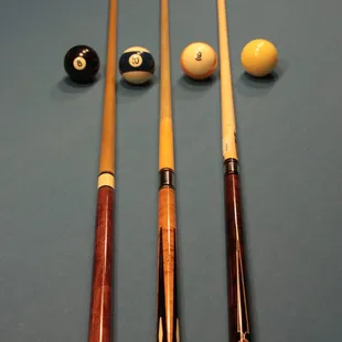 billiards and cues on a pool table