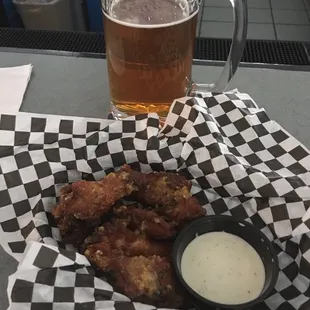 a basket of fried chicken and a glass of beer