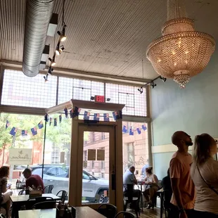 people sitting at tables in a restaurant