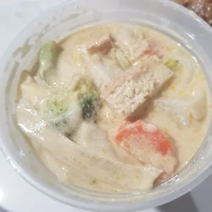 Yellow curry with tofu, made vegan.  Coconut creamy!