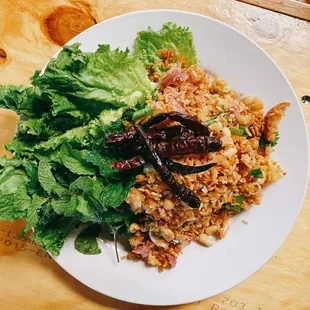 a plate of fried rice and lettuce