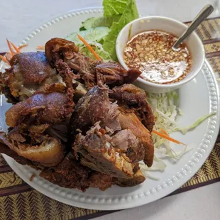 a plate of food and a bowl of dipping sauce