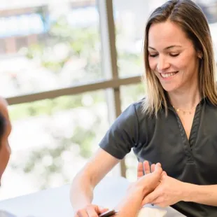 Therapist using the IASTM technique to a patient