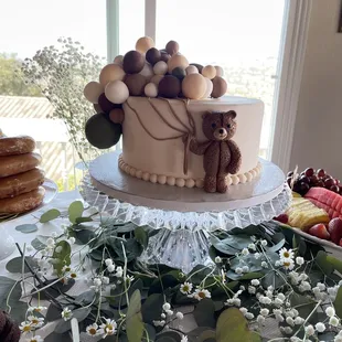 a cake with a teddy bear on top