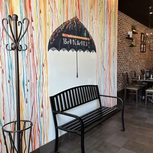 a bench with an umbrella painted on the wall