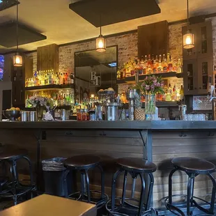 a bar with stools and a television