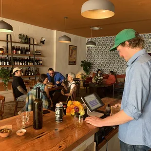 a man using a laptop at a bar