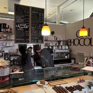 a man and a woman working behind the counter